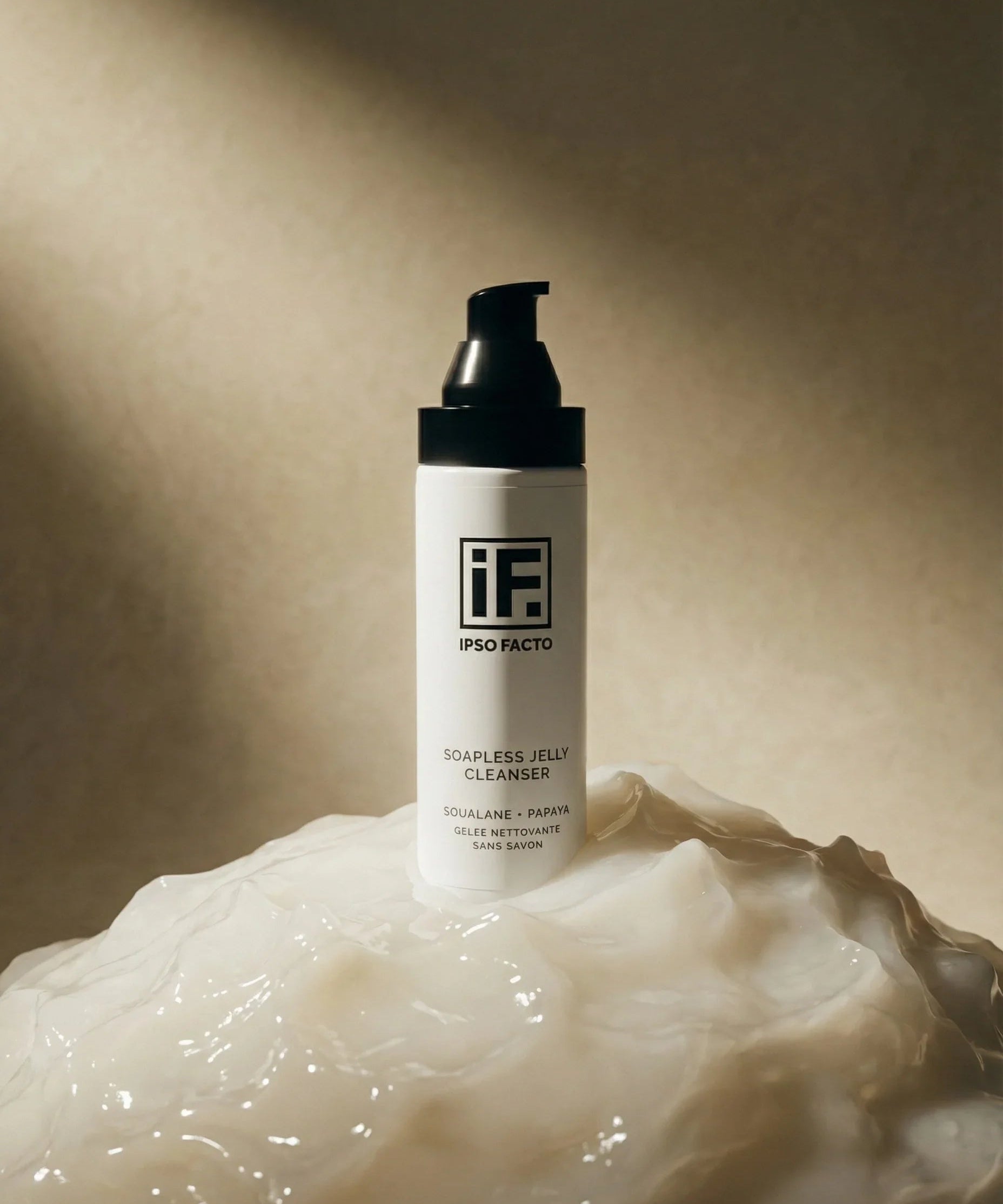 Soapless jelly cleanser bottle on translucent skincare gel with soft lighting