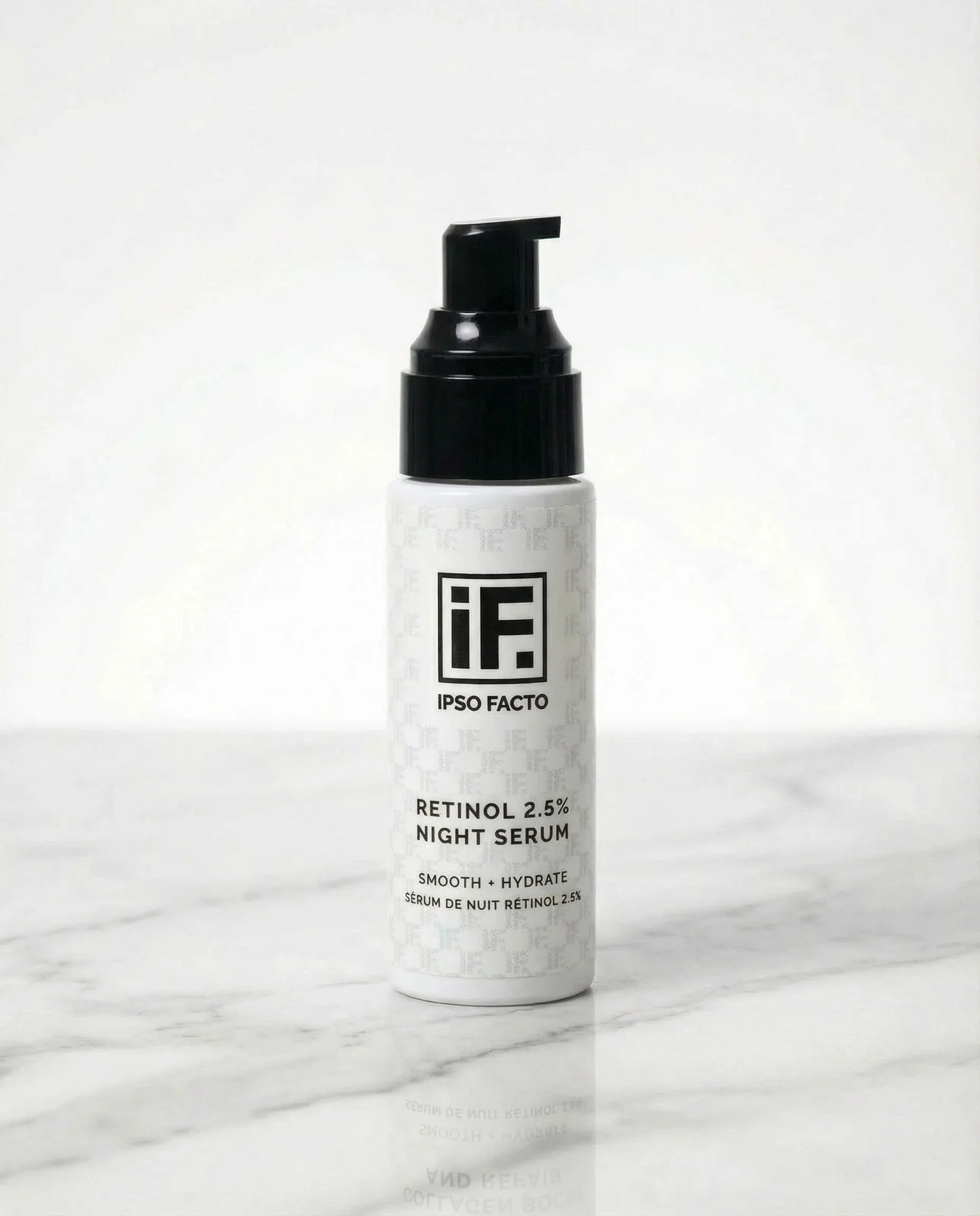 Retinol 2.5% night serum bottle with black pump on marble surface, skincare product