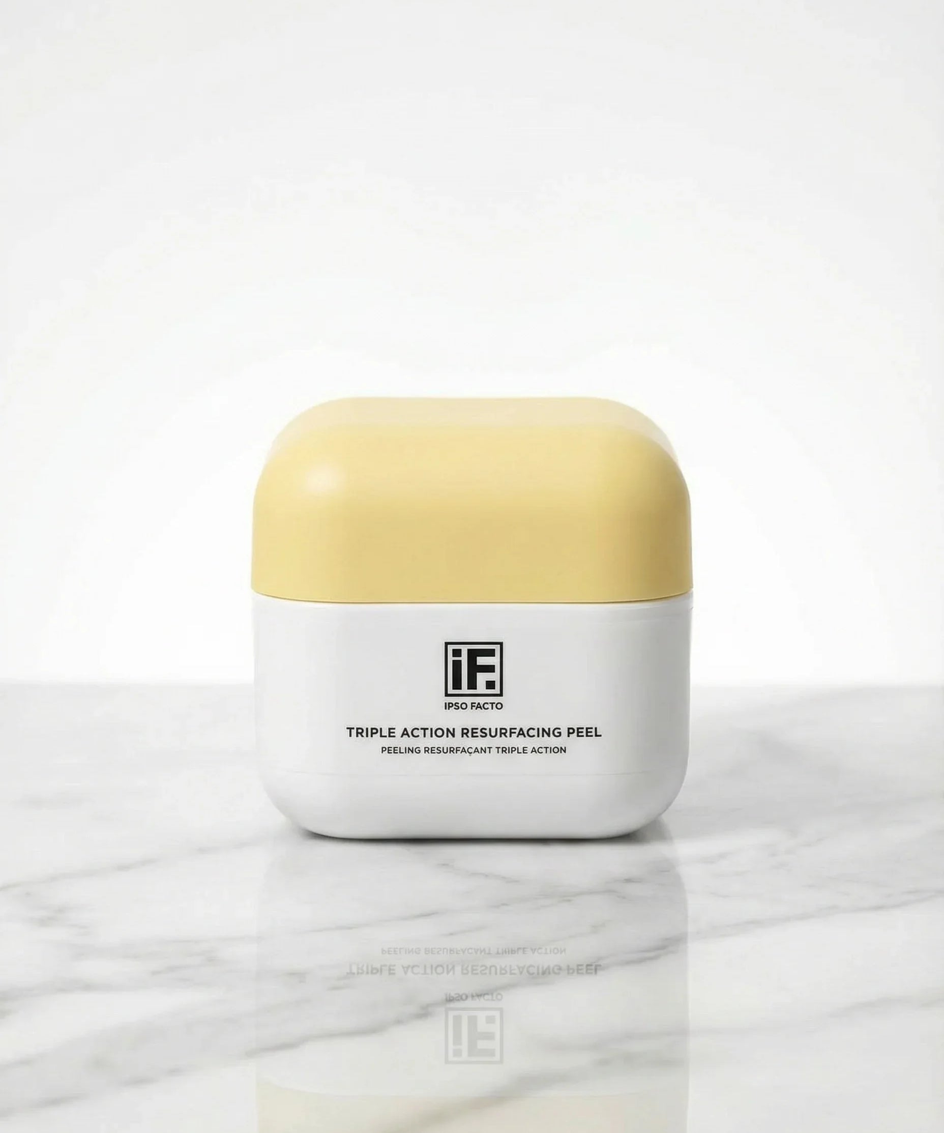 Triple Action Resurfacing Peel skincare jar with yellow lid on marble surface