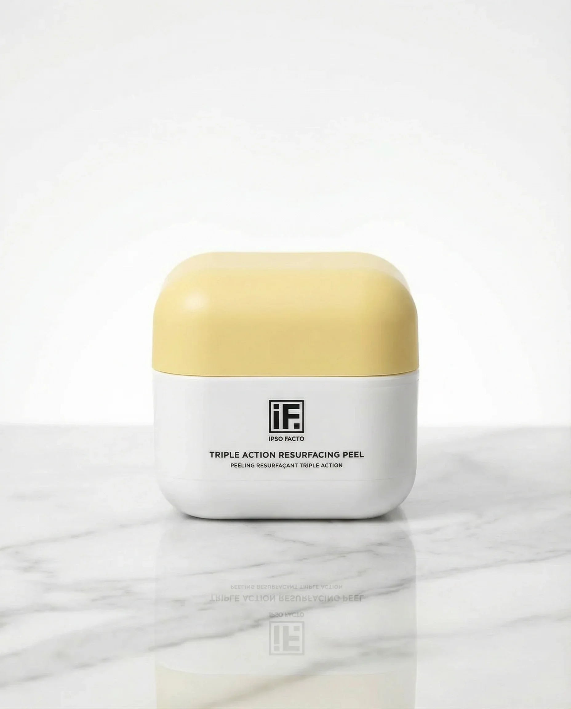 Triple Action Resurfacing Peel skincare jar with yellow lid on marble surface