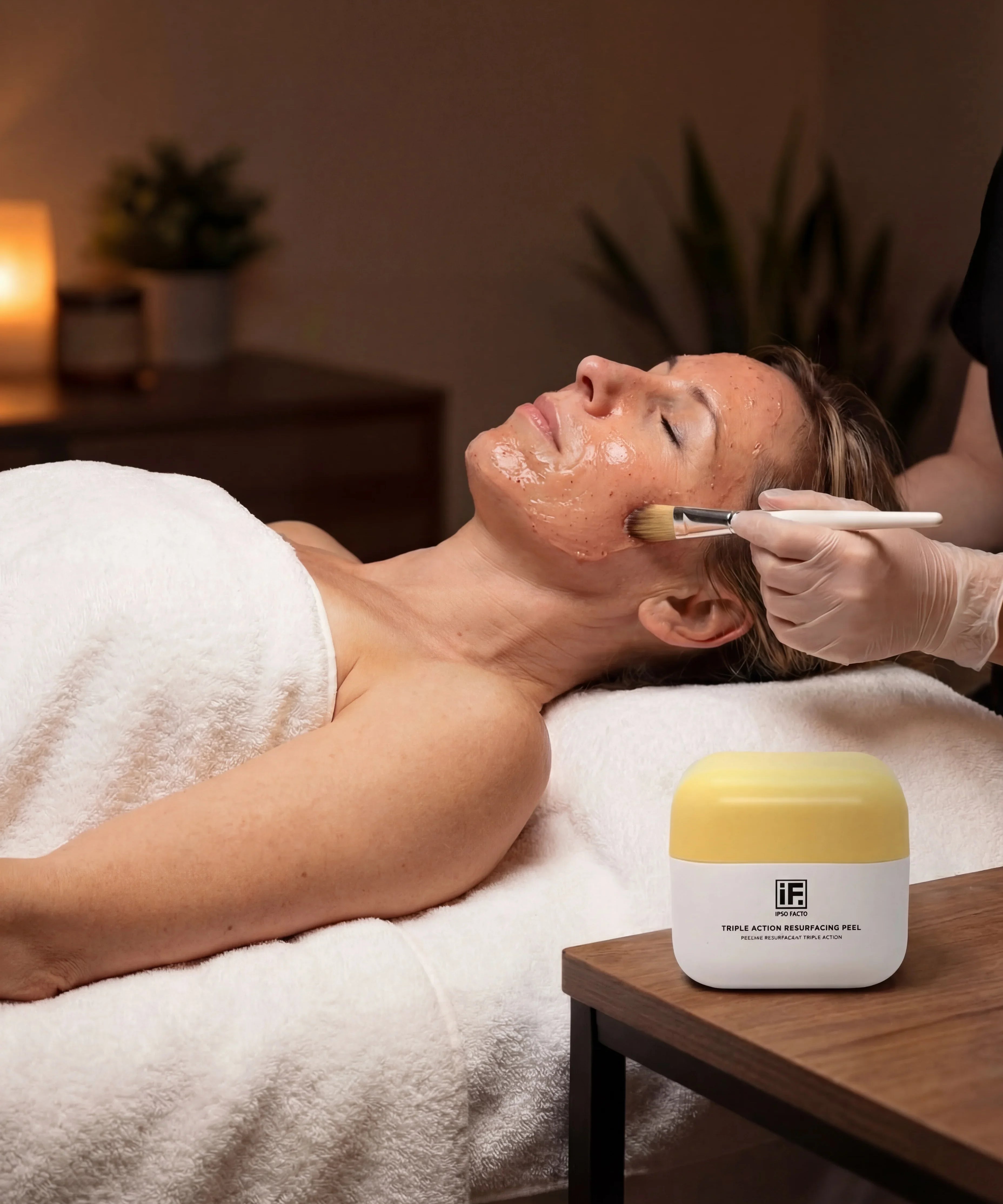 Facial treatment with resurfacing peel applied to woman's face in spa setting